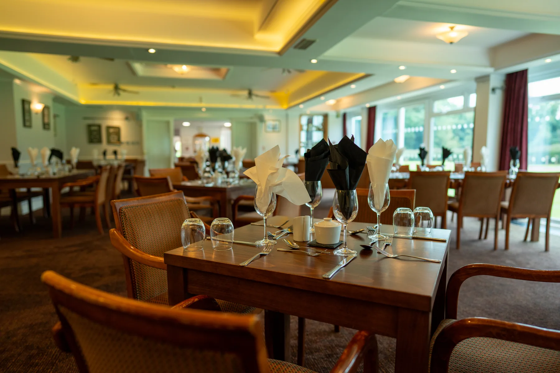 The dining room at Long Ashton Golf Club laid for service in original project photography.