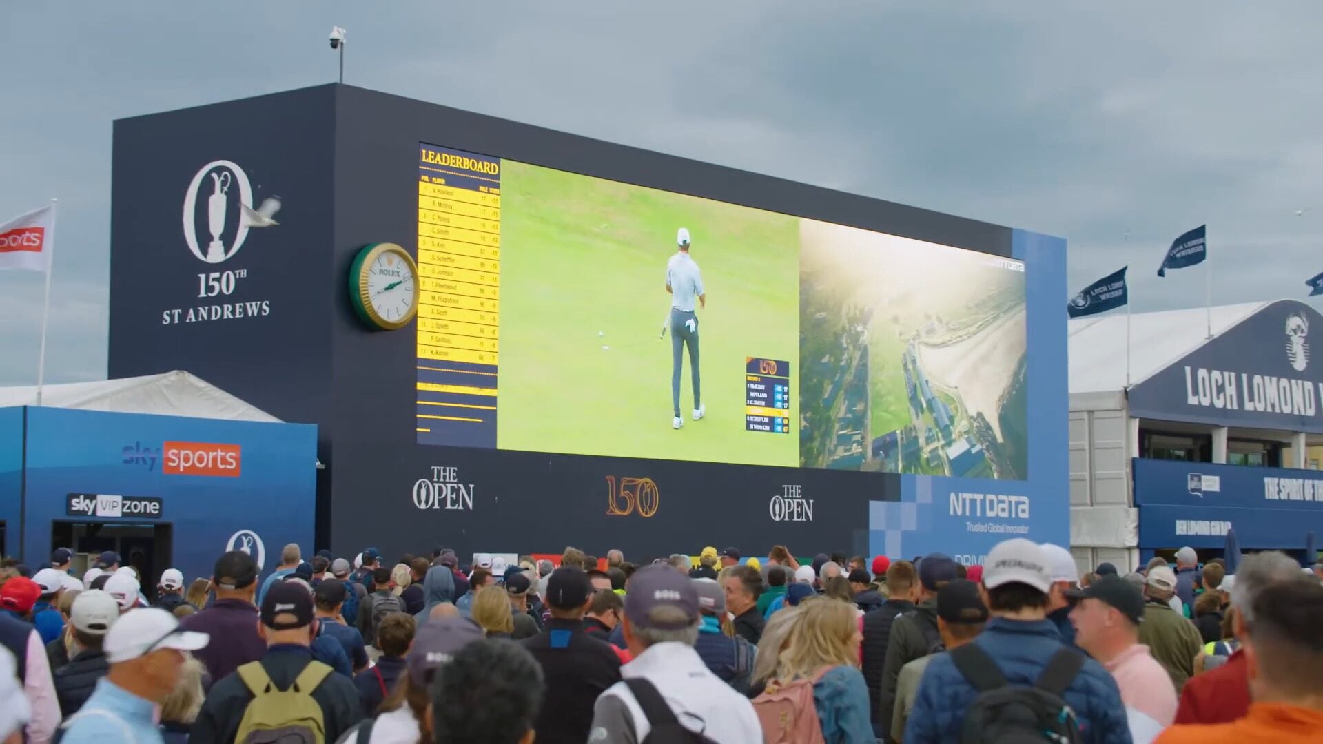 Golf fans watching the NTT DATA WALL at the 150th Open in St Andrews.