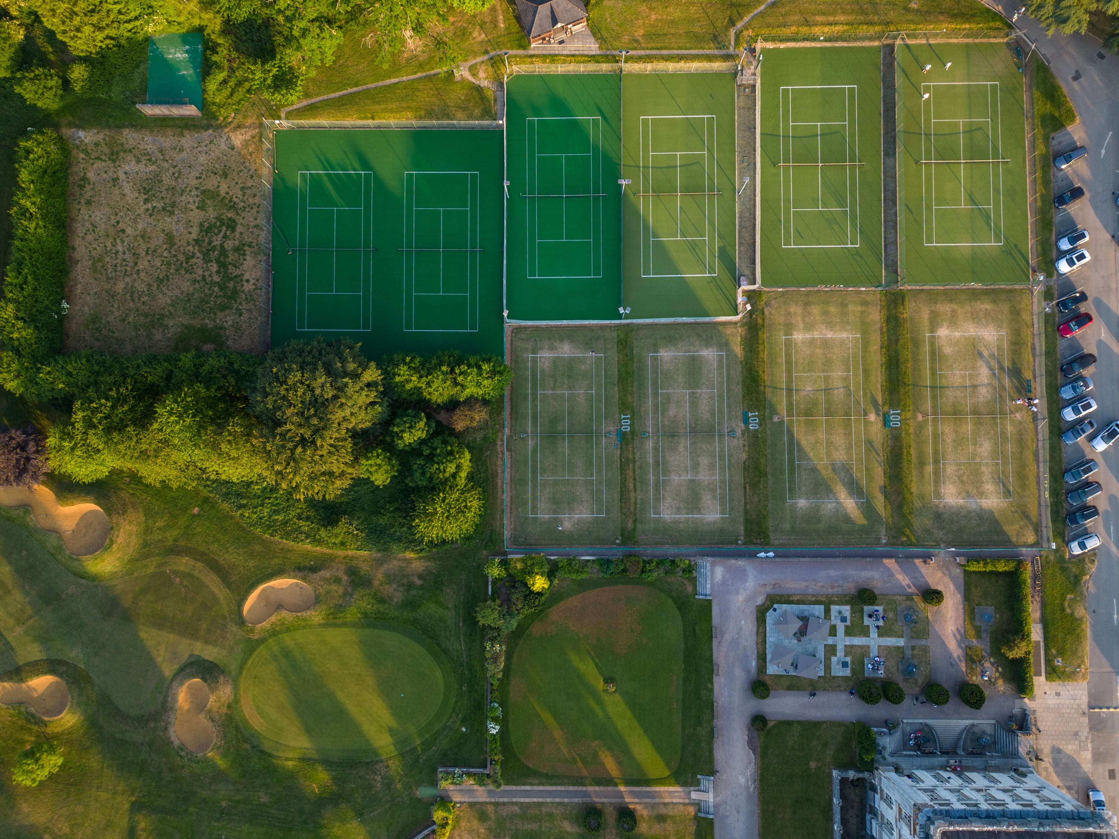 Aerial view of Moor Park's tennis courts beside the golf course and clubhouse terrace.
