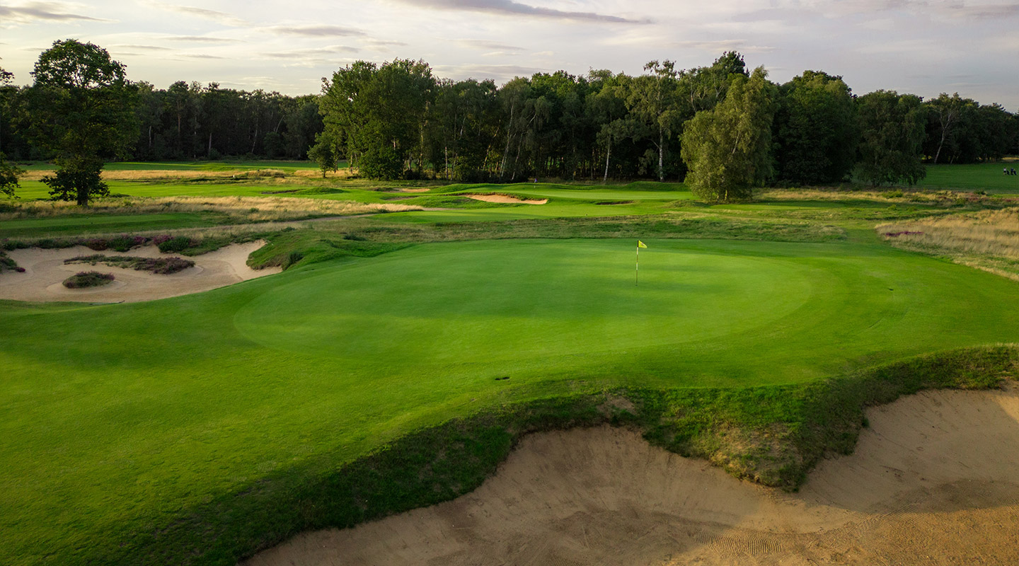 A Woodhall Spa green and surrounding bunkers in low evening light.